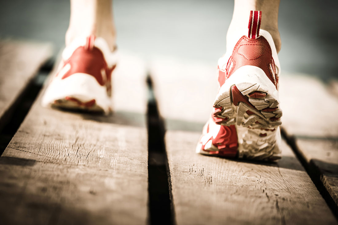 Running shoes on a wooden plank deck