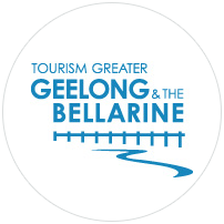 Tourism Greater Geelong and the Bellarine logo featuring blue text and a graphic of a winding path beneath a series of vertical lines, all enclosed in a white circular background.