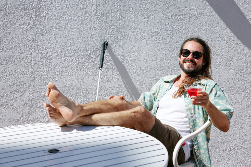 visually impaired man enjoying a drink on holidays