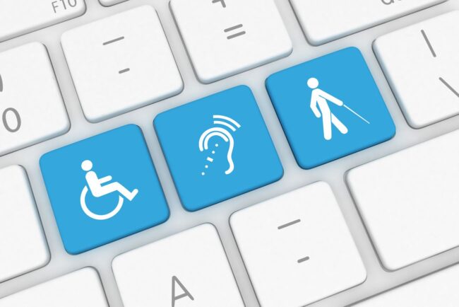 Digital Accessibility and Inclusive Design Keyboard keys displaying accessibility icons, including wheelchair access, hearing assistance, and a person using a white cane, representing digital accessibility and inclusive design.