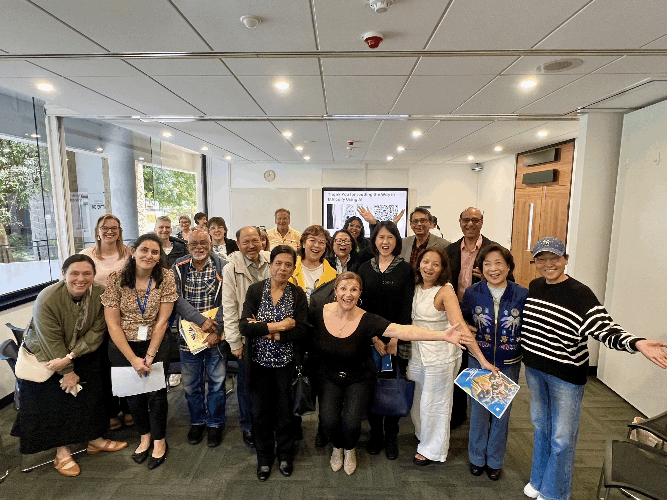 Participants gathered at the Institute of Excellence Ethical AI Community Grants workshop, smiling and celebrating shared learning in responsible AI use.
